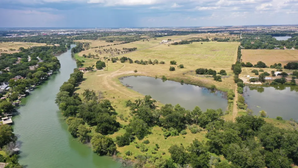 Open ranch land and mature trees in New Braunfels, Texas